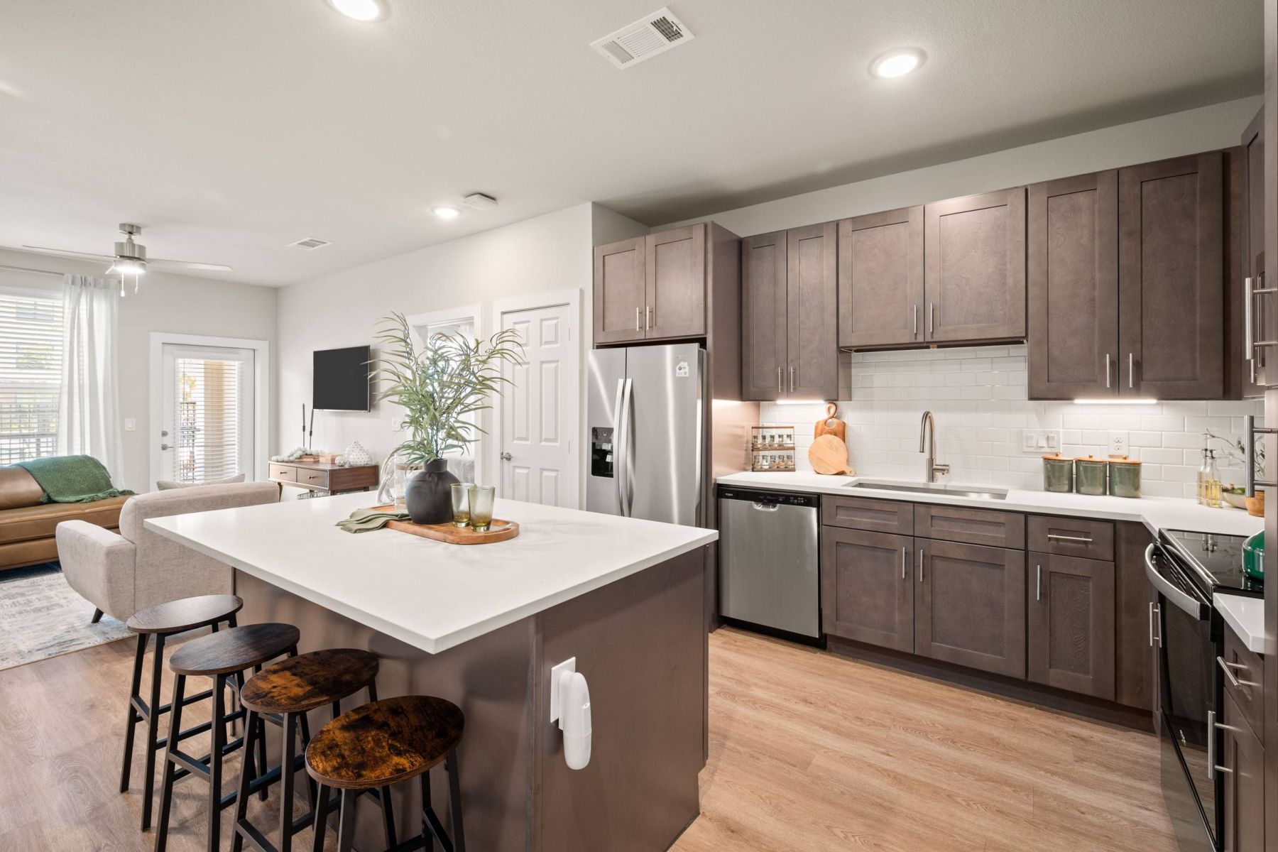 Luxury apartment kitchen with stainless steel appliances, granite countertops, and lots of storage space